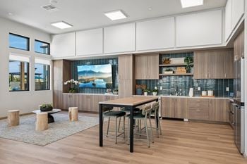 Community kitchen with island and wood cabinetry